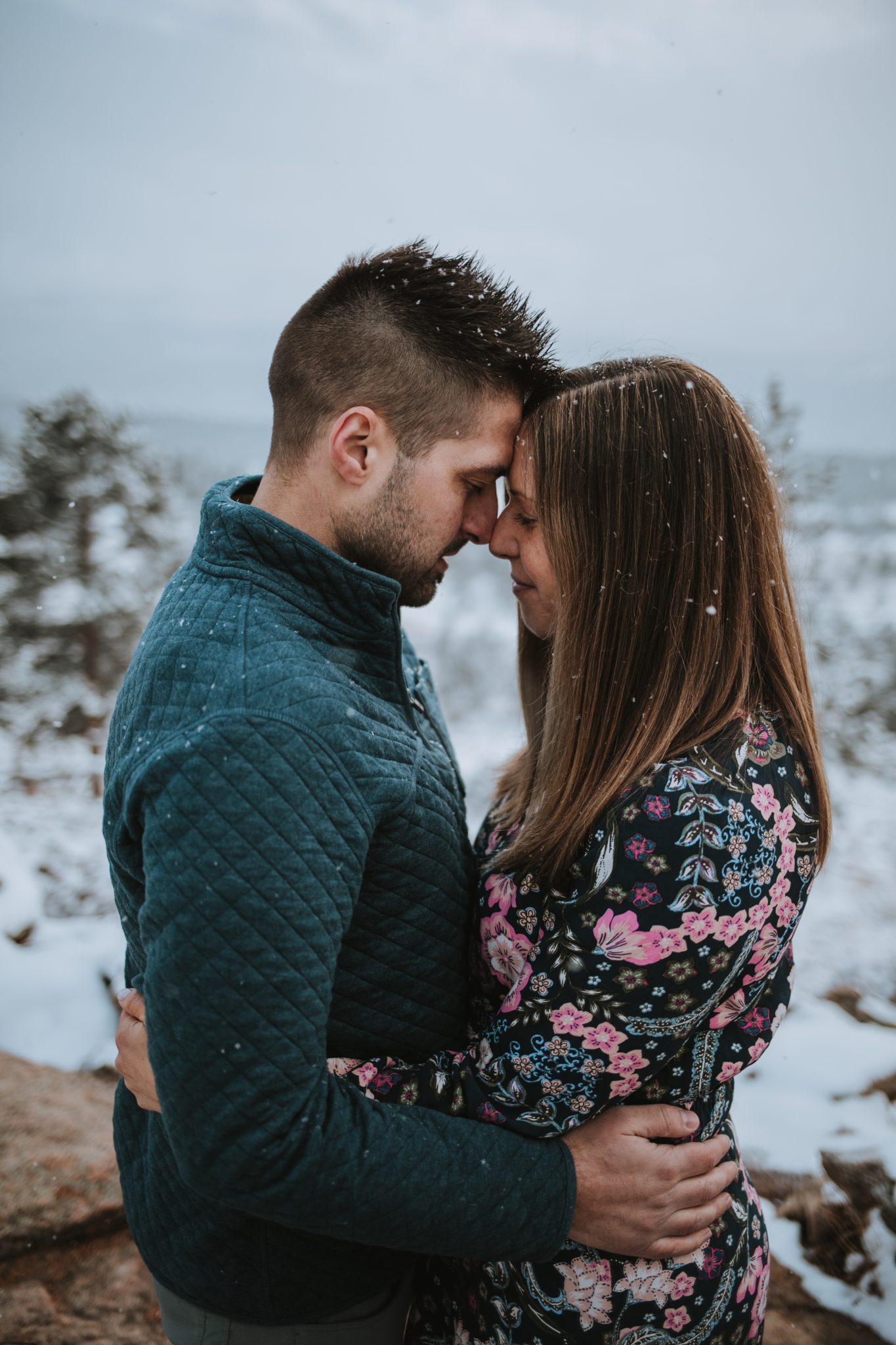 Couple embracing with scenic Rocky Mountain backdrop