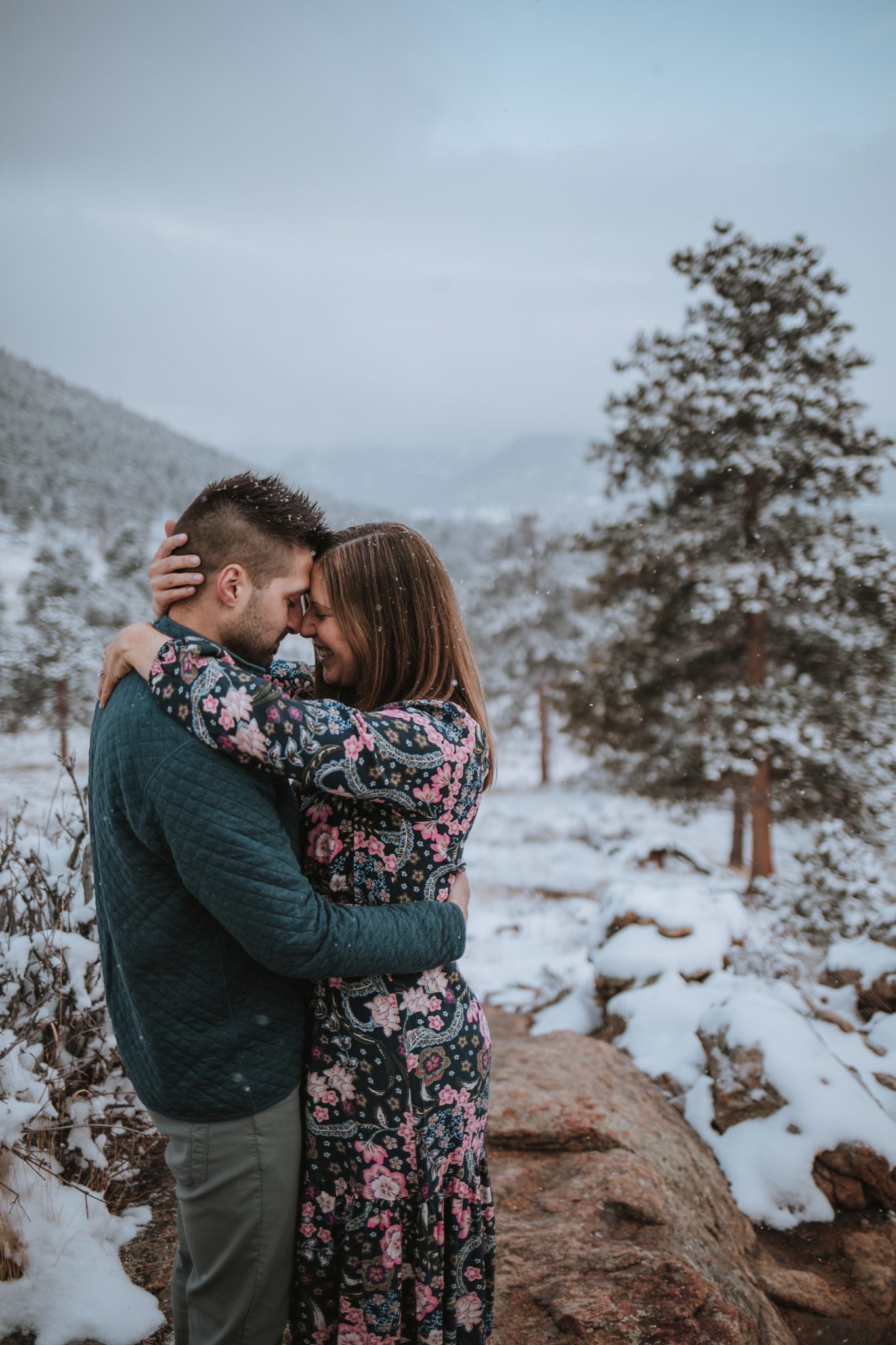 Couple embracing with scenic Rocky Mountain backdrop