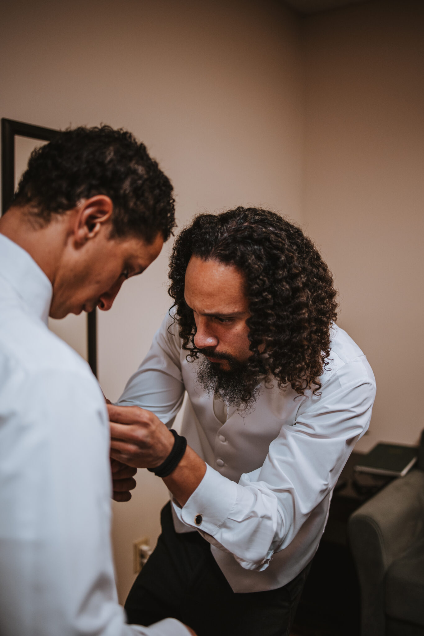 Groom adjusting his tie before walking down the aisle at Wedgewood Black Forest Colorado Springs