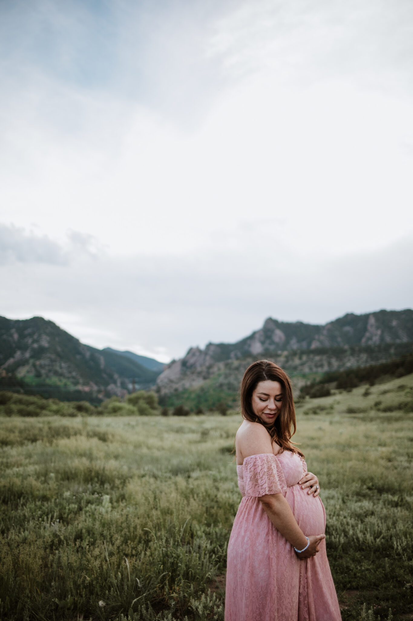 Romantic maternity portraits with Flatirons views in Boulder, Colorado